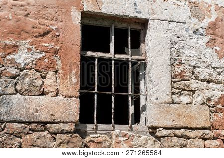 Rusty Window Grille And Old Block Brick Wall