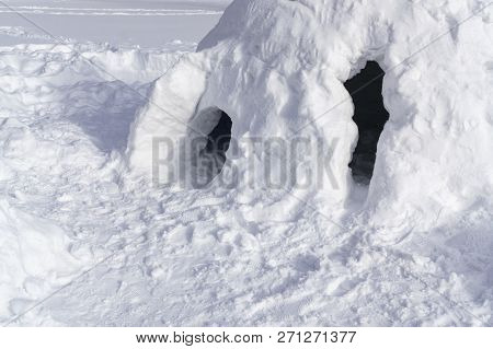 Snow House In Shape Of Igloo. Winter Kids Amusement. Sunny Day