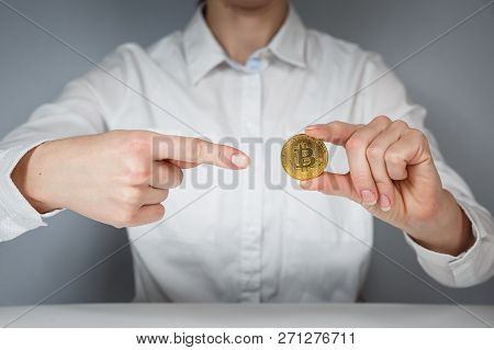 Golden Bitcoin In A Man Hand, Digitall Symbol Of A New Virtual Currency