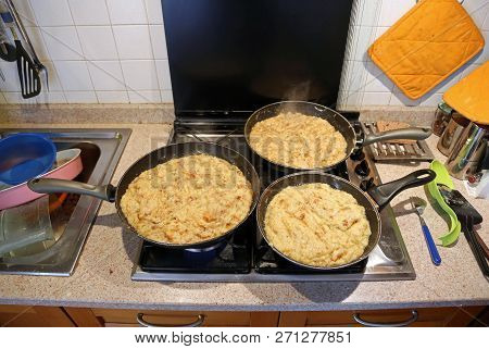 Three Big Pans With Food Named Frico A Typical Italian Dish With Potatoes And Cheese