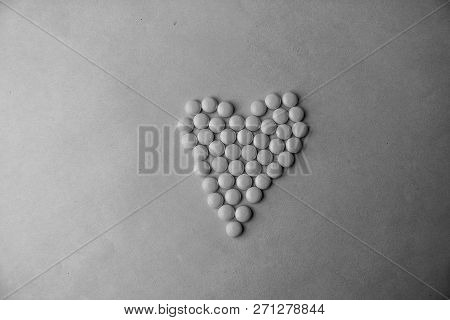 Small Medical Pharmaceptic Round Pills, Vitamins, Drugs, Antibiotics In The Form Of A Heart On A Bla