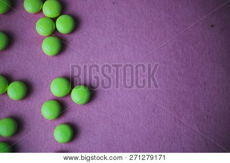 Little Beautiful Medical Pharmaceptic Round Green Pills, Vitamins, Drugs, Antibiotics On A Violet Pi