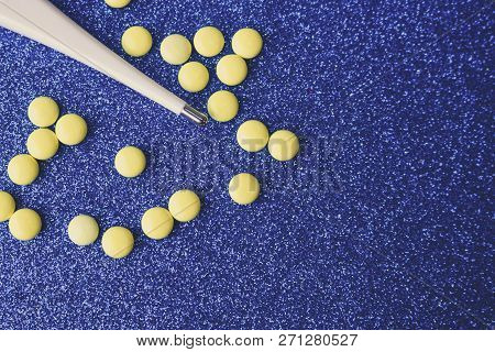 Small Medical Pharmacetic Round Tablets, Vitamins, Drugs And Electronic Digital Thermometer On A Blu