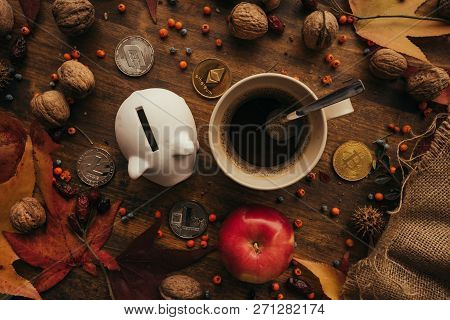 Piggy Coin Bank And Cryptocurrency Coins On Table With Autumn Season Edcoration Arrangement, Top Vie