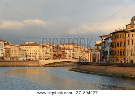 View On Embankment Of Arno River And Bridge Ponte Di Mezzo At Sunset In Pisa, Italy