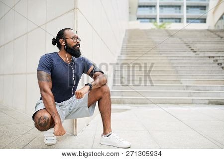 Stylish Fir Innonesian Young Man Having Short Break After Jogging In Moe Morning