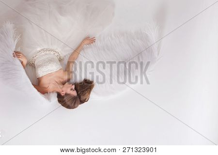 Girl In White Dress With Angel Wings On White Background. Angel-woman