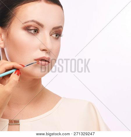 Beautiful Woman With Makeup Brush. Do Face Mascara