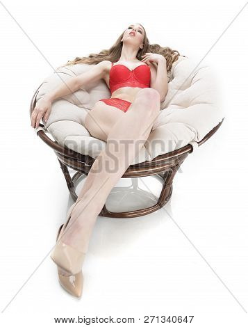 Beautiful Woman In Red Underwear Relaxing In A Round Chair Papasan .photo With Copy Space