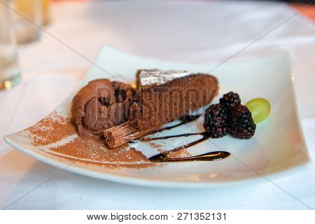 Brownie Cake With Chocolate Ice Cream And Blackberries