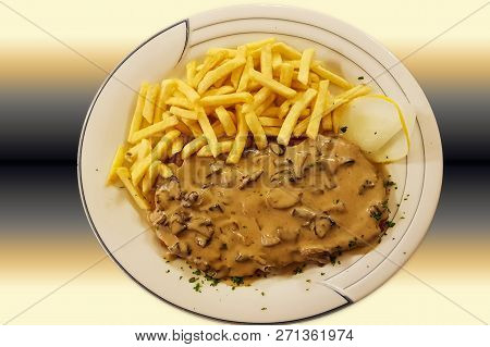 Jaeger Viennese Schnitzel With French Fries And Mushrooms Close-up On A Plate. Horizontal Top View F