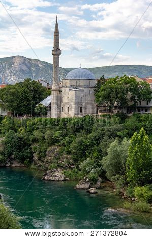 Koski Mehmed Pasha Mosque On The Banks Of The Neretva River In Mostar, Bosnia And Herzegovina On A S