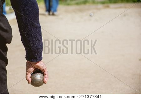 Senior People Prepared To Throw The Boules Ball In A Park In Outdoor Play