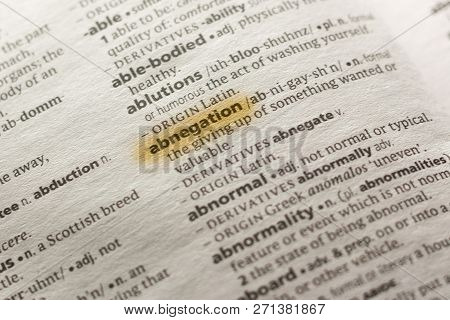 The Word Or Phrase Abnegation In A Dictionary Highlighted With Marker.