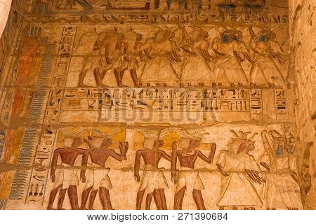 Egyptian Hieroglyphs And Drawings On The Walls And Columns. Egyptian Language, The Life Of Ancient G
