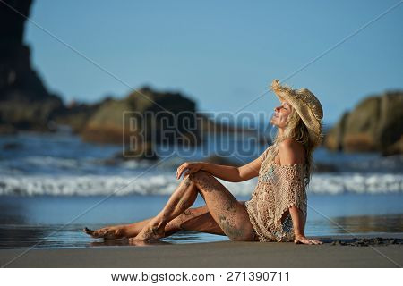 young woman relaxing on the beach in summer day