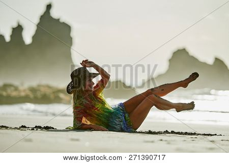 young woman relaxing on the beach in summer day