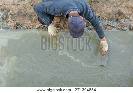 Workers Pour Concrete Solution At A Construction Site .