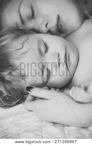 Closeup Of Young Attractive Loving Mother With Light Blonde Curly Hair Embracing Small Tiny Cute Mal
