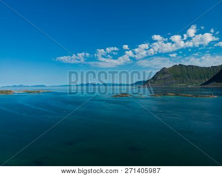 Coast Of Gimsoya Island In Summertime. Sea With Mountains. Nordland County, Lofoten Archipelago Norw
