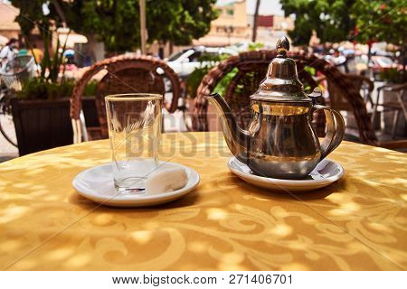 A Glass And A Traditional Tea Pot On A Table In Morocco
