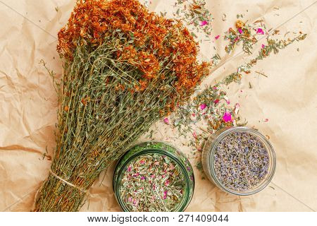 Bunch Of Dried Flowers, Hypericum, Phytotherapy Herbs Tutsan And Glass Jars With Herbs Lavender And 