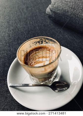 Glass Of Picolo Latte Coffee On Sofa / Cortado
