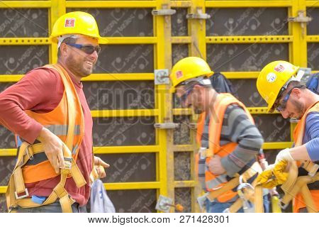 Moscow, Russia - May 22, 2018: Workers In Helmets On The Construction Site. Construction Works