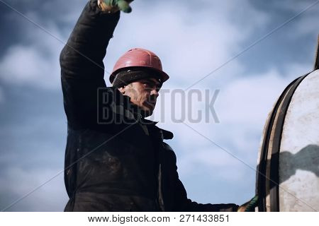 Irkutsk, Russia - March 24, 2017: Slinger At Work. Stroply Cargo. Worker In A Helmet.
