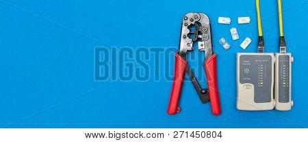 Cripmer Tool And Network Cable Tester Isolated On The Blue Background. Network Maitenance Background