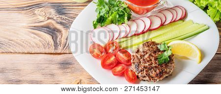 Chopped Steak Cutlet Cooked On Grill On White Plate With Assorty Mix Vegetables Radish Cherry Tomato
