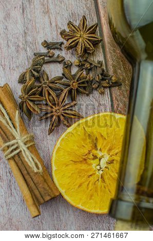 Hot Mulled Wine Drink With Lemon, Apple, Cinnamon, Anise And Other Spices In A Glass Cup Between Fir