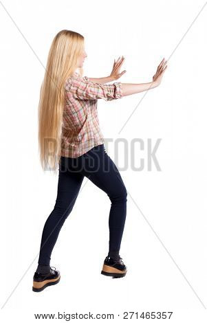 back view of woman pushes wall.  Isolated over white background. Rear view people collection. backside view of person. Blonde pushes the subject in front of her