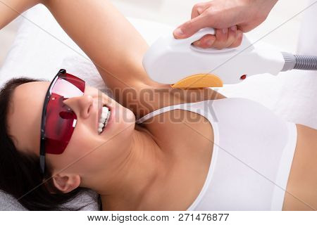 Beautiful Young Woman Having Underarm Laser Hair Removal Treatment In Spa