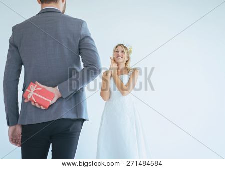 Groom Hiding Red Gift Box Behind Back In Order To Surprise Bride On The Wedding Day,woman Positive E