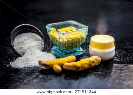 Close Up Of Face Pack Of Rice Flour With Fresh Face Cream And Turmeric Powder On Wooden Surface In A