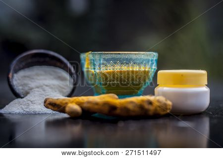 Close Up Of Face Pack Of Rice Flour With Fresh Face Cream And Turmeric Powder On Wooden Surface In A