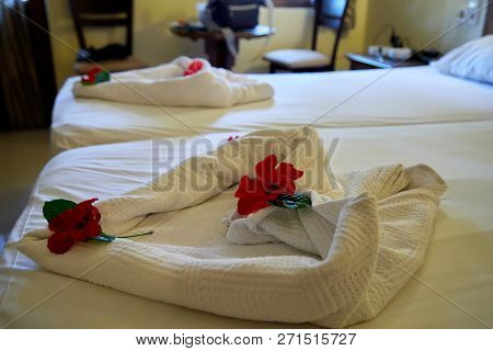 Creative Composition Of White Towels On The Bed Laid Out In The Form Of A Heart
