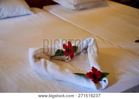 Creative Composition Of White Towels On The Bed Laid Out In The Form Of A Heart