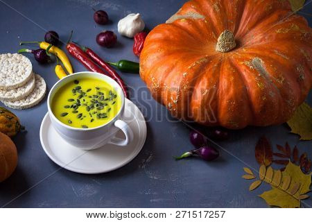 Pumpkin Asian Coconat Cream Soup. Autumn Hot Food. Chili Pepper, Garlic, Red Onion, Big Pumpkin. Dar