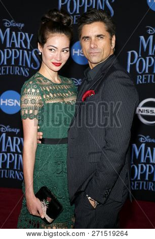 Caitlin Mchugh and John Stamos at the World premiere of Disney's 'Mary Poppins Returns' held at the Dolby Theatre in Hollywood, USA on November 29, 2018.