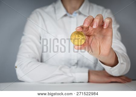 Golden Bitcoin In A Man Hand, Digitall Symbol Of A New Virtual Currency