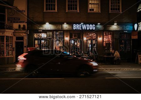 Brighton, England - October 26th, 2018: Night View Of Brewdog Brewery Pub Facade With People Sitting