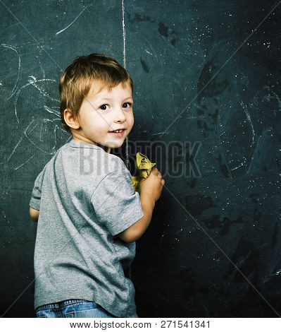 Little Cute Boy With Young Teacher In Classroom Studying At Blac