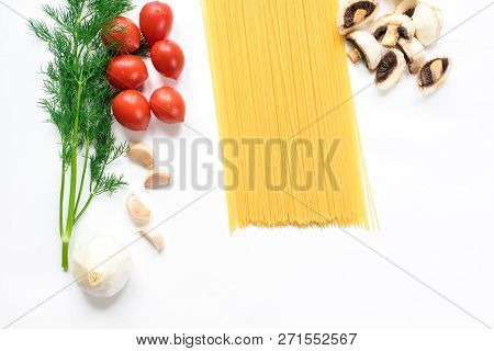 Composition Of Pasta Ingredients Isolated In White. Pasta, Tomatoes, Greens, Mushrooms, Garlic, Top 