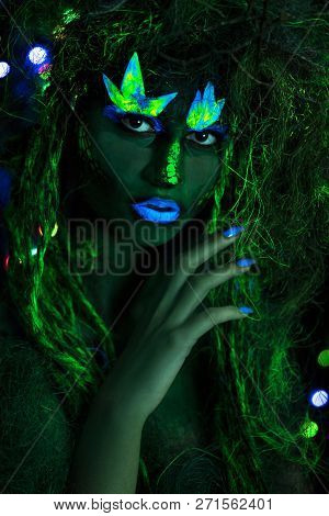 Mystic Green Dryad In Uv Fluor Black Light With Glowing Trees On Background
