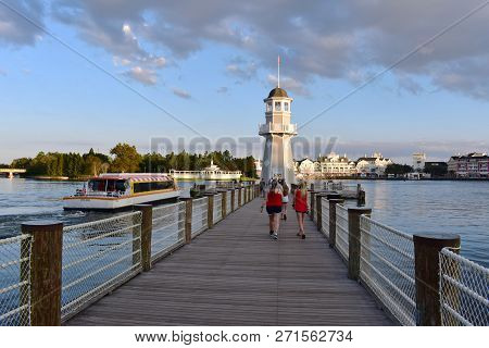 Orlando, Florida. November 15, 2018 Taxi Boat Sailing  And People Walking At Pier On Lighthouse Back