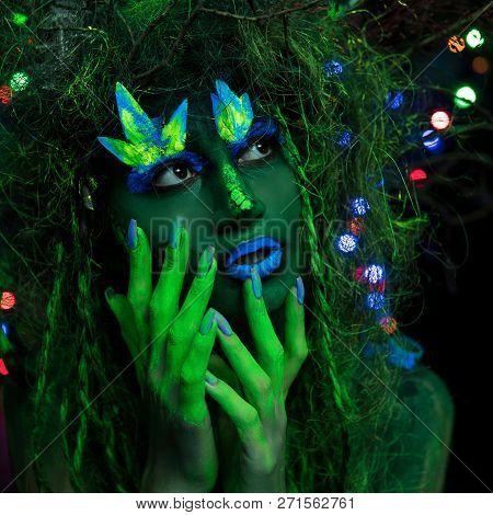 Mystic Green Dryad In Uv Fluor Black Light With Glowing Trees On Background