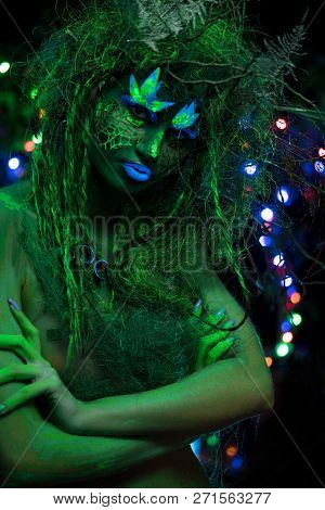 Mystic Green Dryad In Uv Fluor Black Light With Glowing Trees On Background