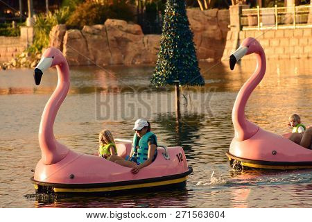 Orlando, Florida. November 19, 2018. People Enjoying Rowing Boats At Dusk In The International Drive